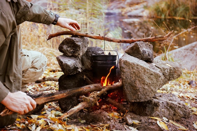 Man making fire in mountains