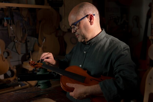 Photo man making instruments in his workshop alone