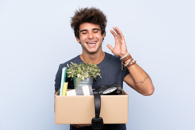 Man making a move while picking up a box full of things laughing