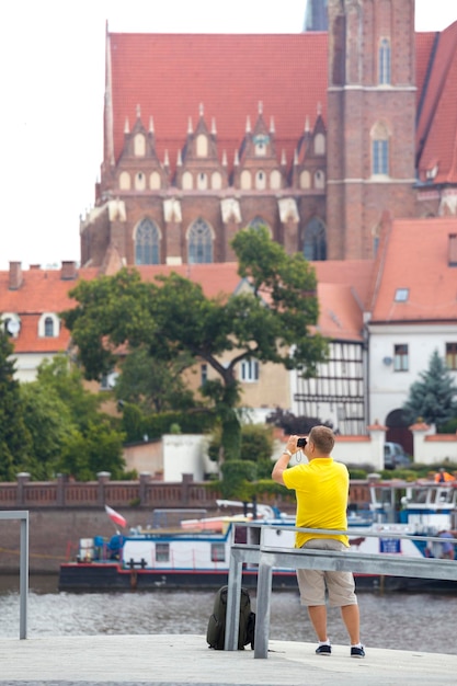 Man making a photo shoot of Wroclaw with the camera