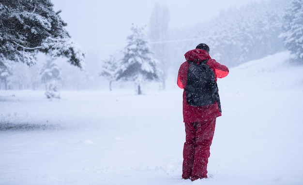 Man making photographs of the snowy forest