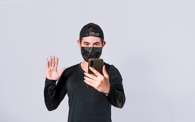 Man making video call isolated guy making video call with face mask face mask video call concept