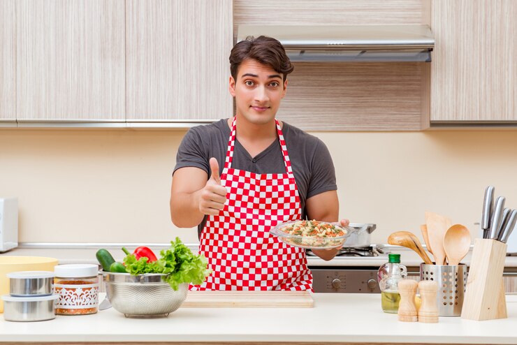 फोटो man male cook preparing food in kitchen