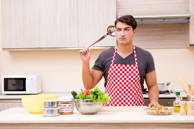 फोटो man male cook preparing food in kitchen