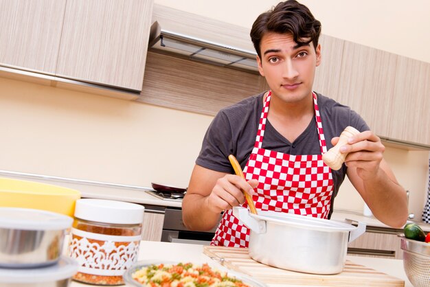 Man male cook preparing food in kitchen