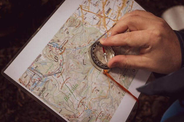 Man marking the azimuth on the map