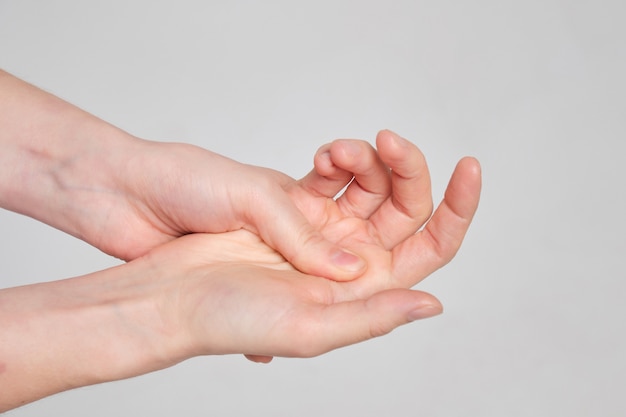 man massages joint in his hand