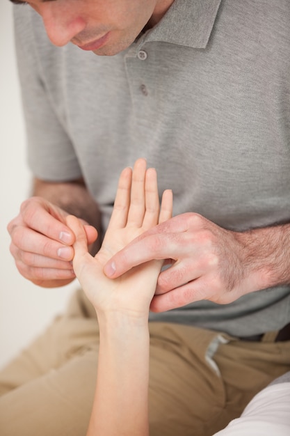 Man masseert de duim van een vrouw