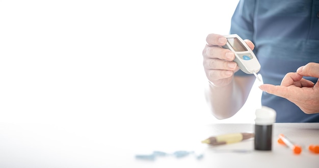 Man measures his blood sugar Glucometer blood sample test diabetes concept