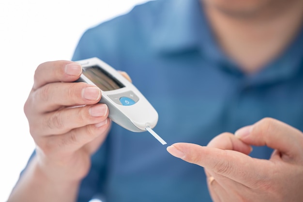 Man measures his blood sugar Glucometer blood sample test diabetes concept