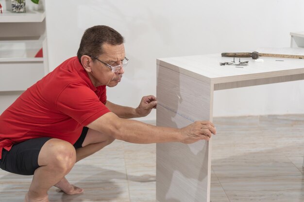 Photo man measuring furniture for assembly