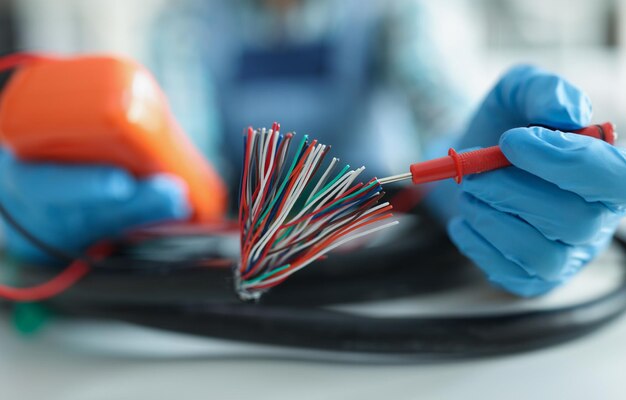 Man measuring voltage with special equipment tool for checking pressure bunch of wires