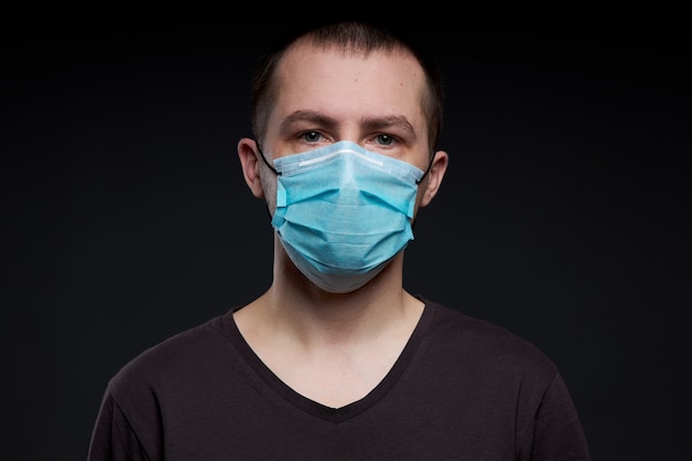 Man in a medical mask on a dark background