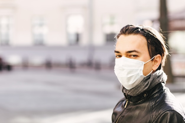 Man in medical mask on his face looking to camera.