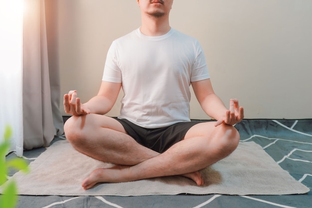 man meditating at his room floor sittingfreedom and calmness concept close up view