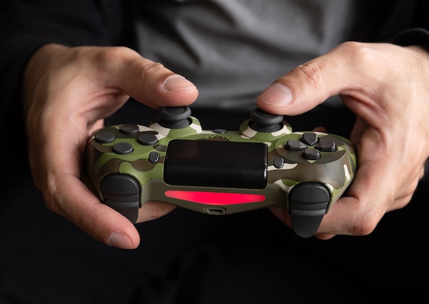 Man met camo game controller - Seletive Focus