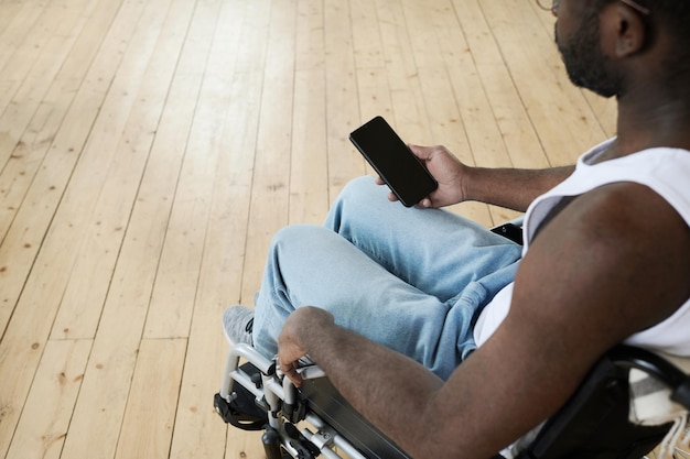 Man met een handicap met behulp van mobiele telefoon