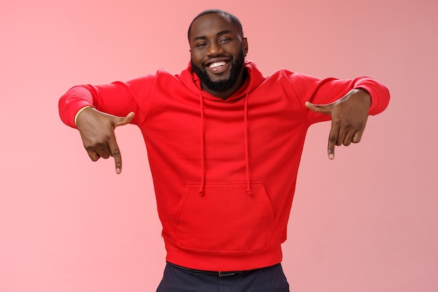 Man met een rood sweatshirt over roze