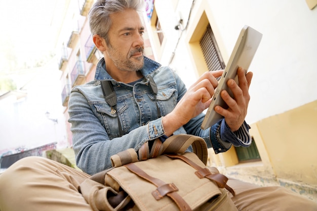 man met een tablet op straat