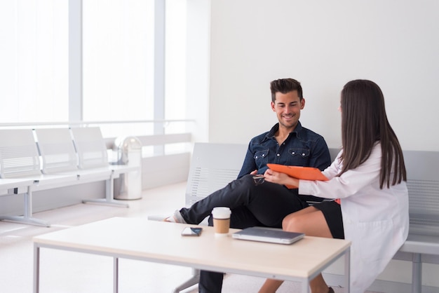 Man met laptop in gesprek met medic