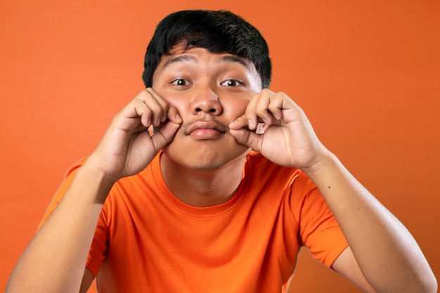 man met snor op oranje achtergrond belachelijk gezicht