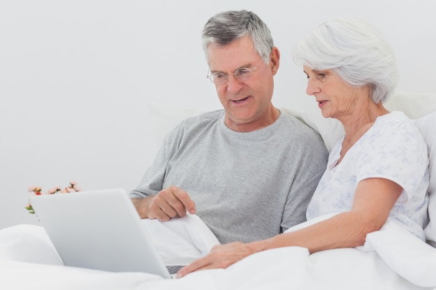 Man met vrouw wijzend op een laptop