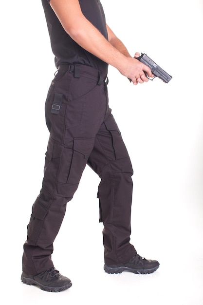 A man in military uniform with a pistol in his hands on a white background