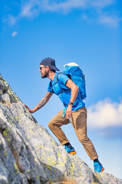 A man during a mountain climb in the wild