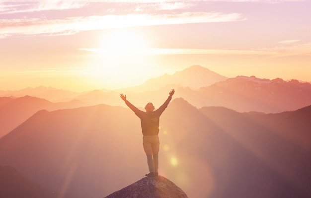 Man on the mountains cliff. Hiking scene.