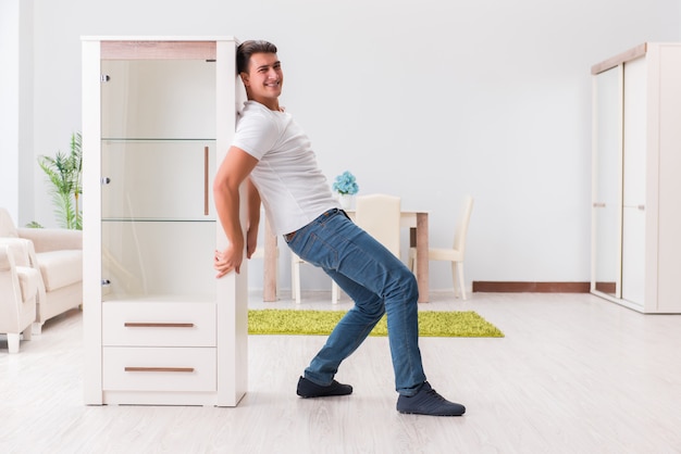 Man moving furniture at home