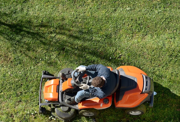 Man mowing a lawn on a ride-on mower