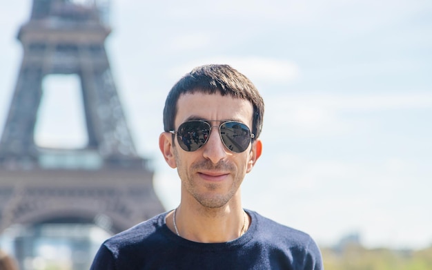 A man near the eiffel tower Selective focus