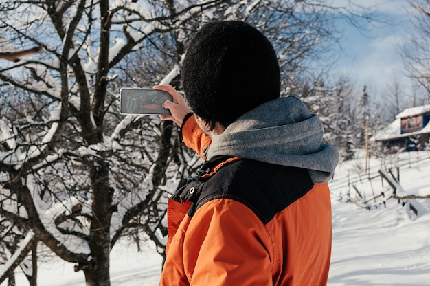 man nemen foto op winter sneeuw dag