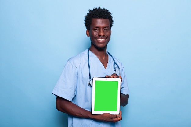 Man nurse showing vertical green screen on tablet