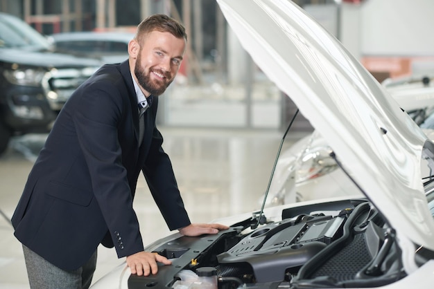 Man observing auto in car center