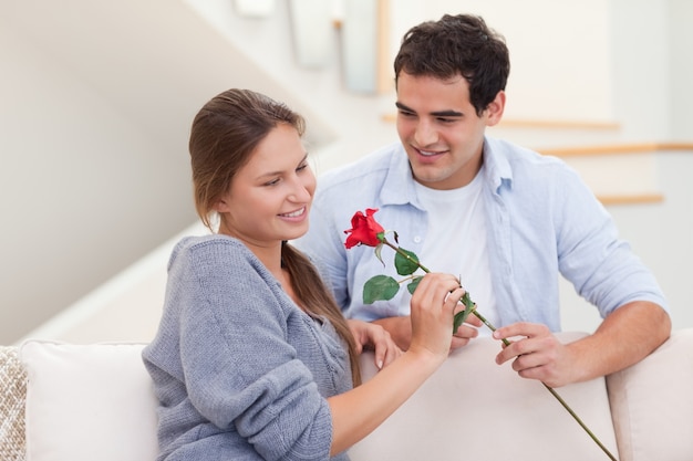 Man offering a rose to his fiance