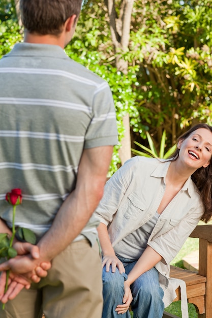 Man offering a rose to his wife