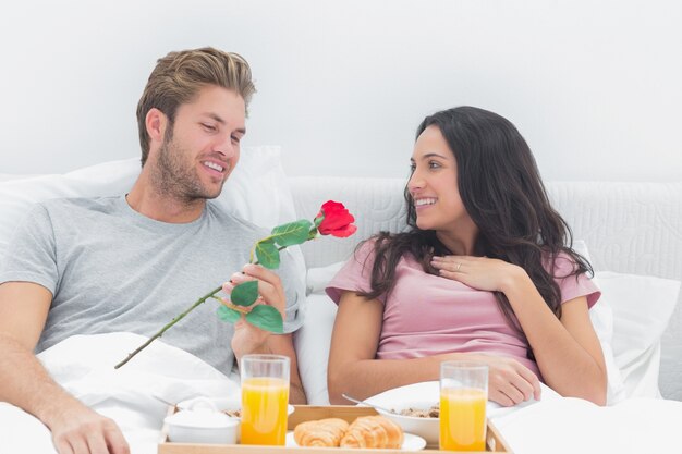 Man offering a rose to his wife