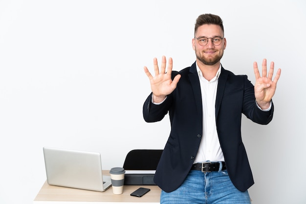 Man in a office isolated on white wall counting nine with fingers