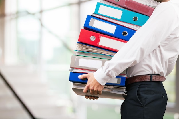 Man office worker holding binders stack