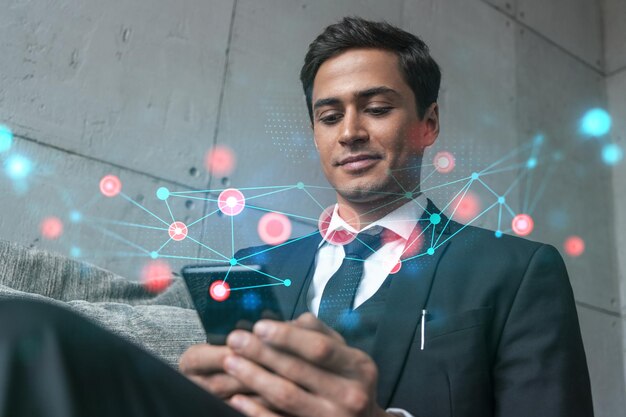 Man in office working with Smartphone Searching for new tech Abstract technology hologram typing phone Double exposure