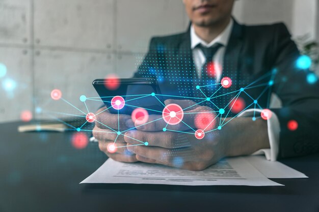 Man in office working with Smartphone Searching for new tech Abstract technology hologram typing phone Double exposure