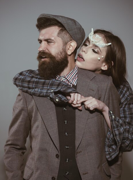 Man old fashioned dressed embraced by girl with thorns as devil dragon magical creature Guy vintage outfit got in trap of woman fantasy creature Halloween outfit ideas concept