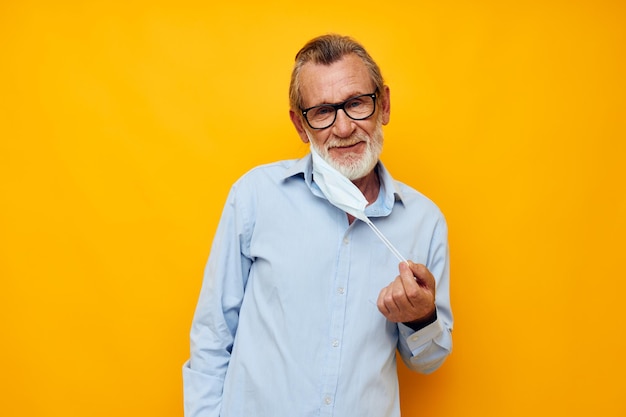 Man old man posing on yellow background