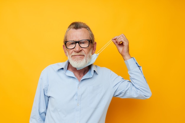 Man old man posing on yellow background