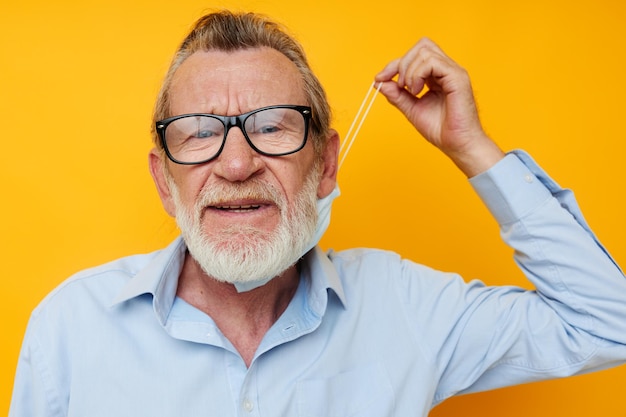 Man old man posing on yellow background