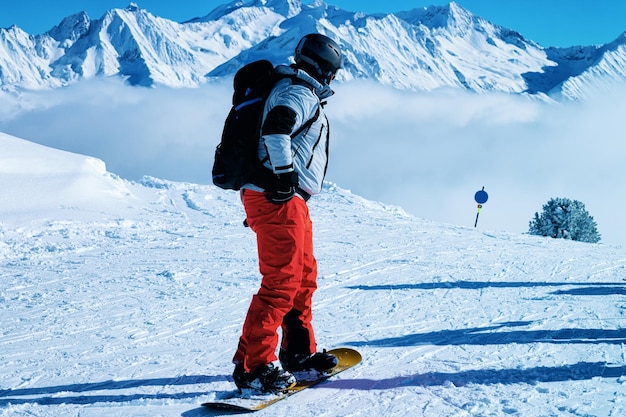 Man op Snowboard in het skigebied Zillertal Arena in Tirol in Mayrhofen van Oostenrijk in de winter Alpen. Alpine bergen met witte sneeuw en blauwe lucht. Downhill-plezier op Oostenrijkse besneeuwde pistes.