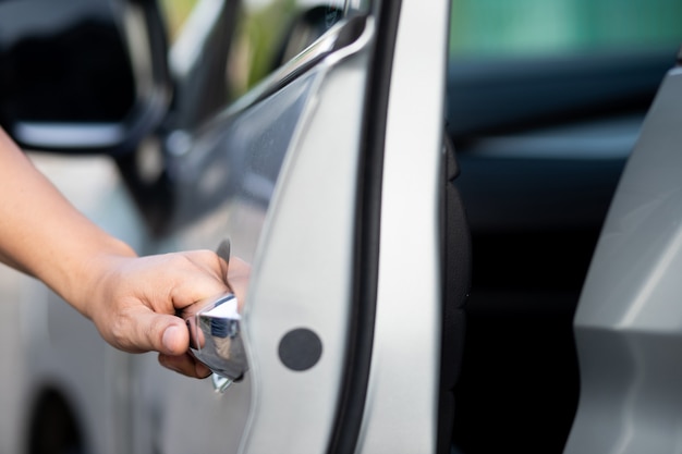 Man opening and closing his car