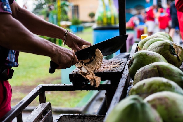 Man opening a coconut