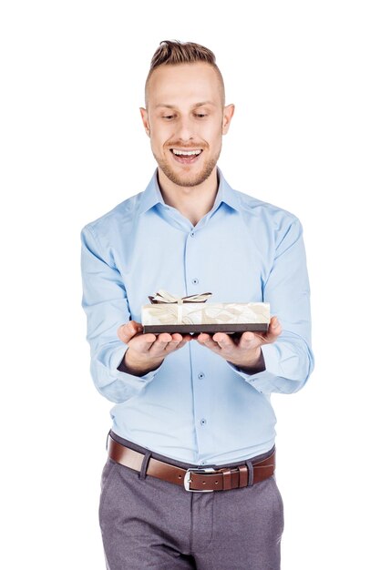 Man opening a surprise gift box with a bow with a look of joyful anticipation as he celebrates